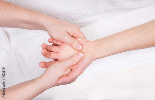 Qualified therapist doing therapeutic palm massage