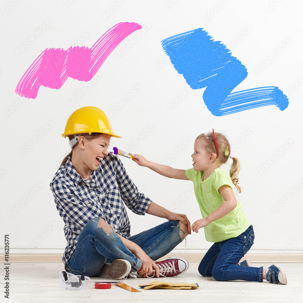 Little girl and young mum with paintbrush coloring the room of new apartment. Happy family having fun decorating their home. Little girl and young mum with paintbrush coloring the room of new apartment. Happy family having fun decorating their home.