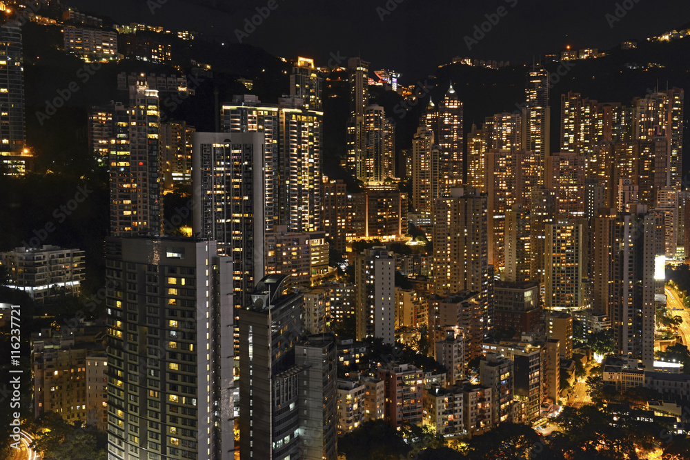 Crowded Hong Kong skyline scene at night with tightly packed skyscrapers and apartment buildings Crowded Hong Kong skyline scene at night with tightly packed skyscrapers and apartment buildings