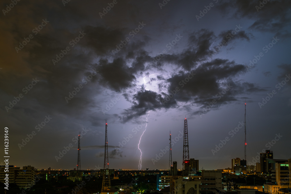 Lightning storm over city in purple light
