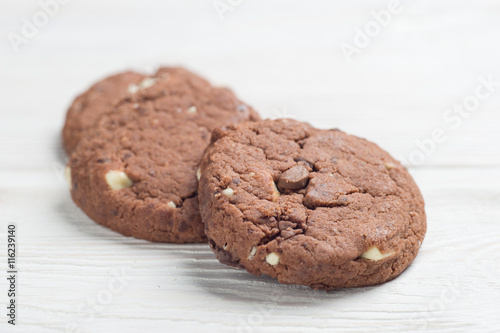 Fresh chocolate cookies on white table photo
