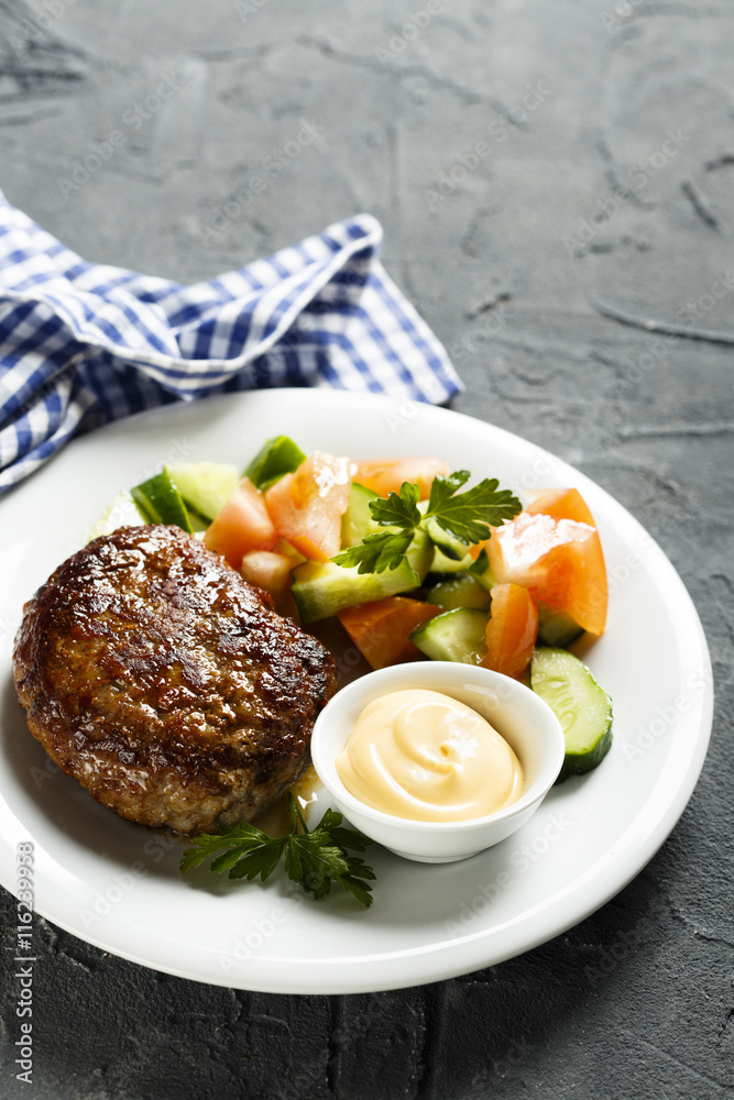 Beef burger with vegetable salad and sauce