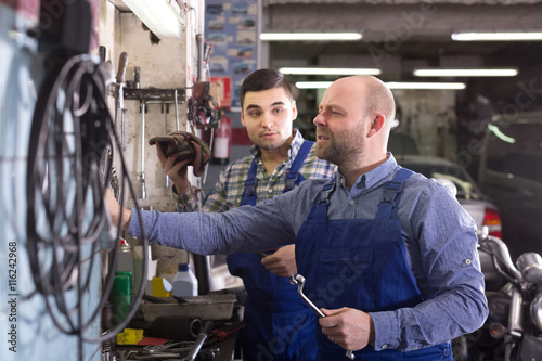 men working at carshop
