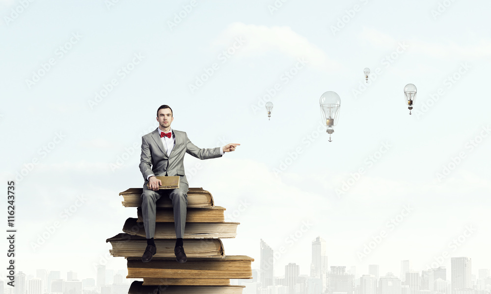 Businessman with old book . Mixed media Businessman with old book . Mixed media