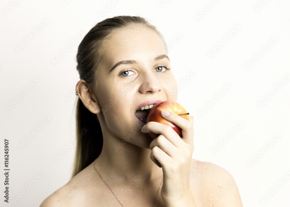 beautiful naked young woman eating an apple. healthy food - strong teeth concept beautiful naked young woman eating an apple. healthy food - strong teeth concept