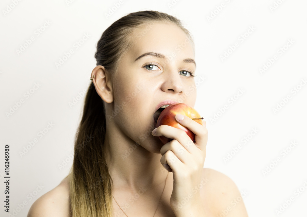 beautiful naked young woman eating an apple. healthy food - strong teeth concept beautiful naked young woman eating an apple. healthy food - strong teeth concept