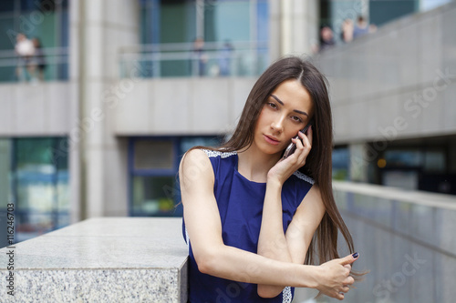 Beautiful young brunette woman calling by phone © Andrey_Arkusha