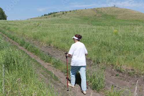 Nordic Walking - elderly woman is hiking