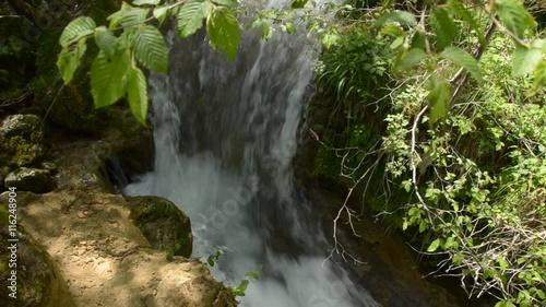 Detail of falling water of a fast mountain creek on Zlatibor Mountain in Serbia photo