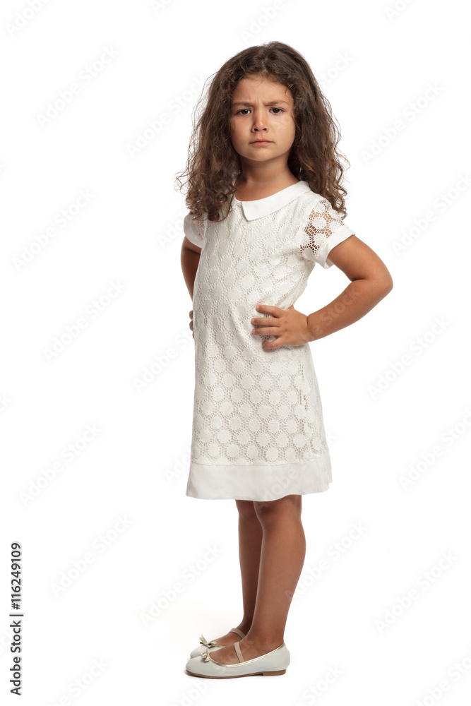 Portrait of a angry little girl on white background looking at the camera Portrait of a angry little girl on white background looking at the camera