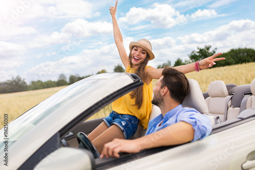 Couple enjoying a drive in a convertible   © pikselstock