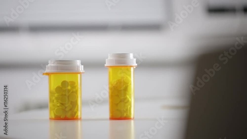 Man takes a bottle of pills on the table
