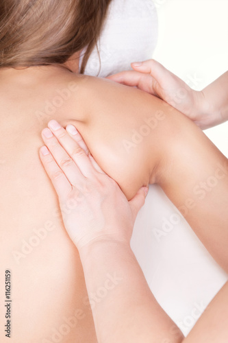 Therapist doing massage around shoulder blade