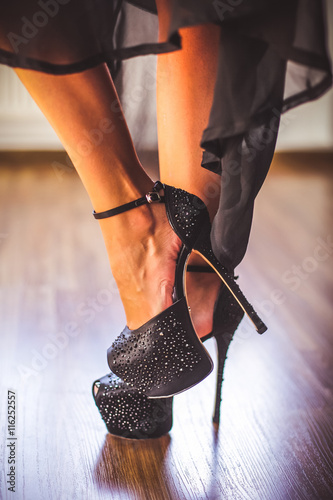 Woman legs in stylish black shoes photo