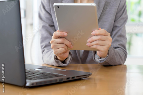 Businesswoman in office working on digital tablet