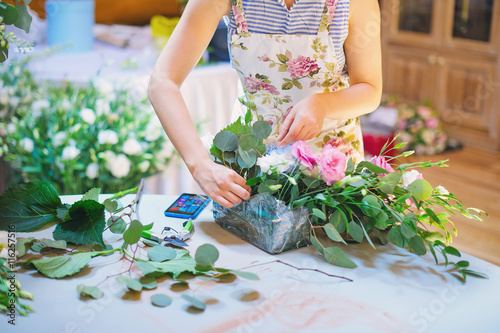 Hands of florist woman creating bouquets for wedding decoration