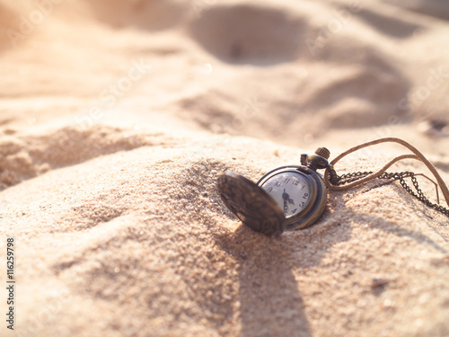 Vintage necklace watch on the sand