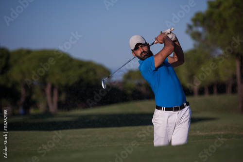 pro golfer hitting a sand bunker shot