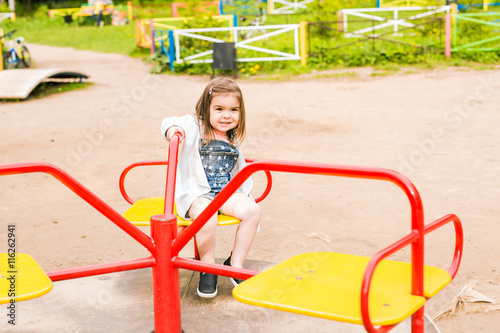 little girl on the summer playground