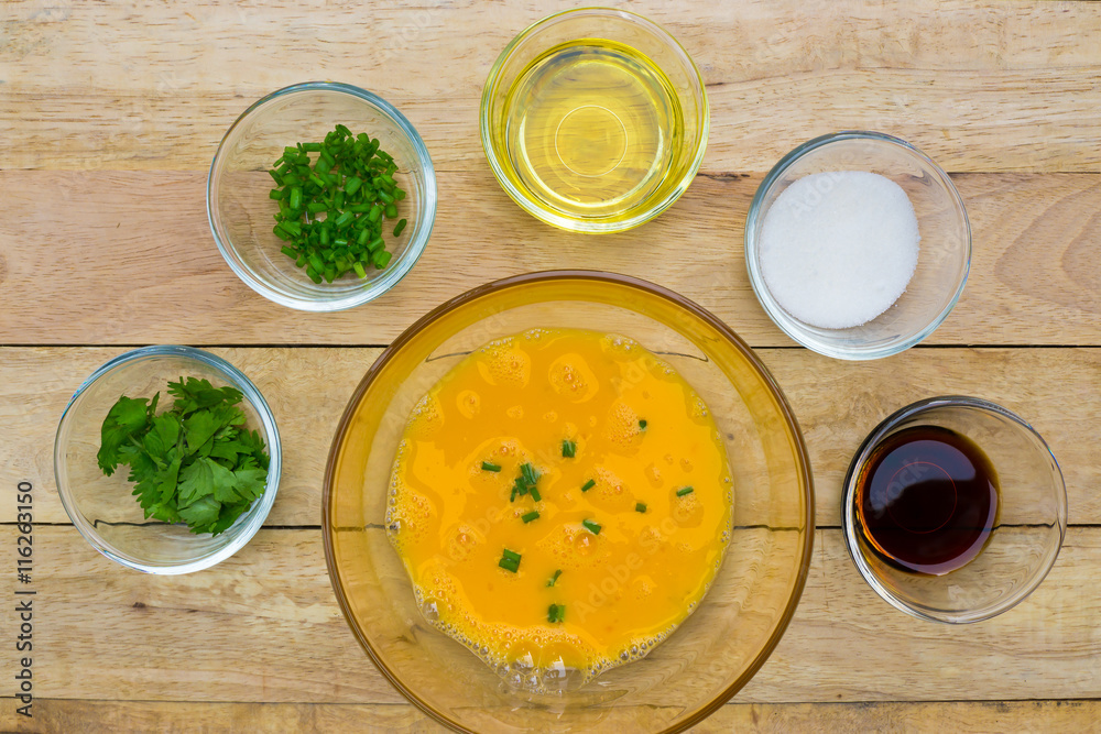 Raw eggs and ingredients on wooden background. Vegetarian food, health or cooking concept. Raw eggs and ingredients on wooden background. Vegetarian food, health or cooking concept.