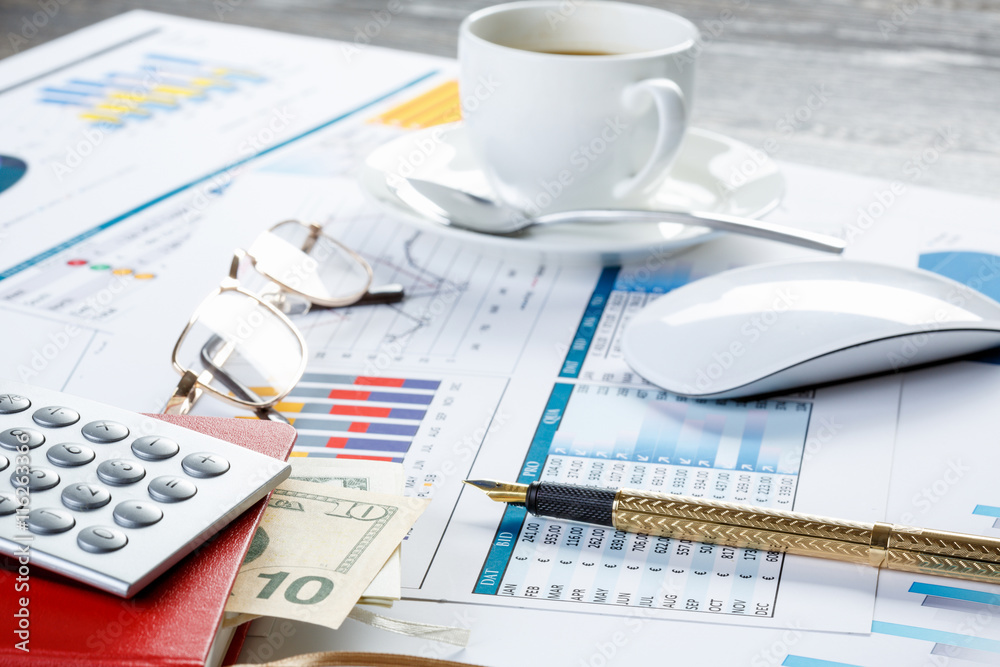 Financial charts and graphs on the table Financial charts and graphs on the table