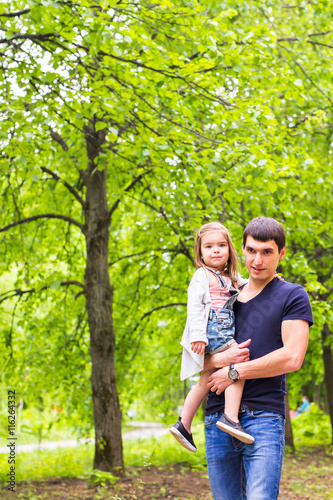 Happy father with daughter in summer park