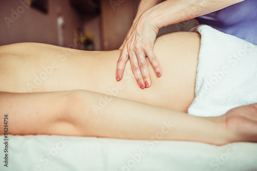 Physiotherapist doing a massage technic on deep muscle. Lumbar.