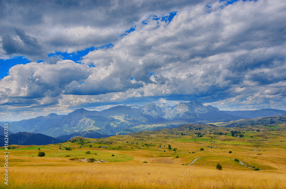 Montenegro, national park Durmitor, mountains and clouds panorama. Sunlight lanscape. Nature travel background Montenegro, national park Durmitor, mountains and clouds panorama. Sunlight lanscape. Nature travel background