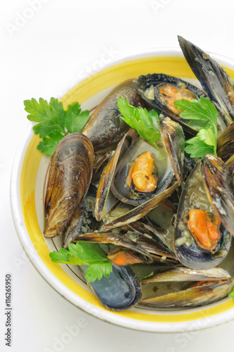 Mussel soup with fresh parsley on white background