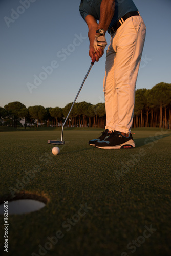 golfer hitting shot at golf course