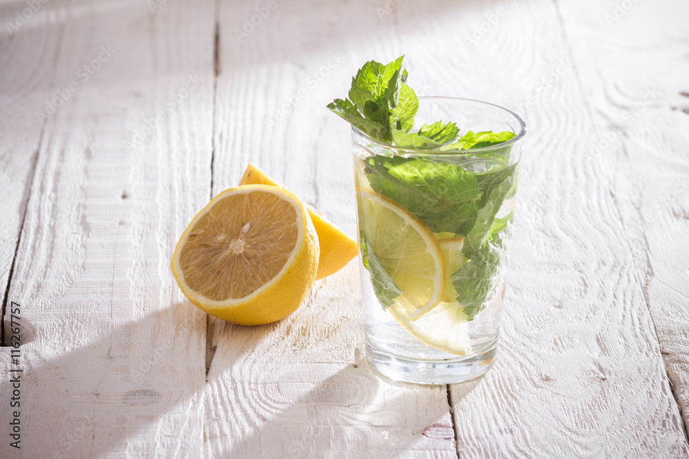 Fototapeta premium Soft drink with lemon, ice and mint