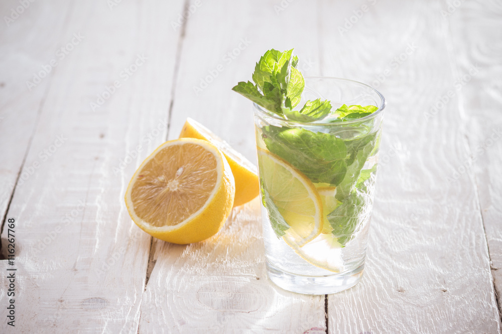 Fototapeta premium Soft drink with lemon, ice and mint