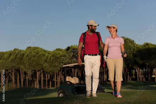 couple walking on golf course