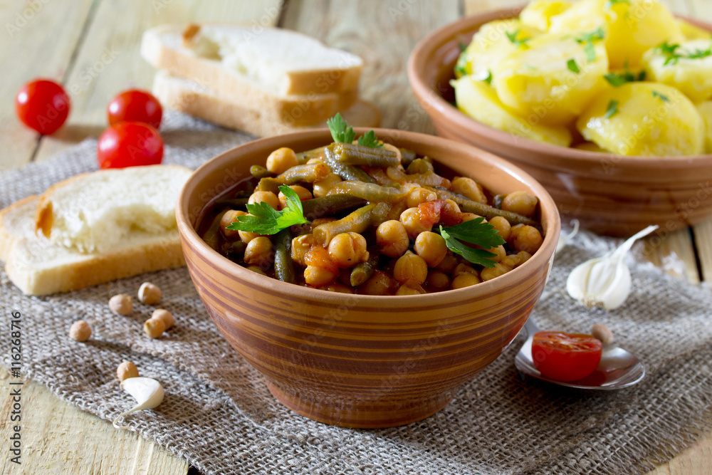 Vegetarian vegetable stew with chickpeas and green beans on a ru