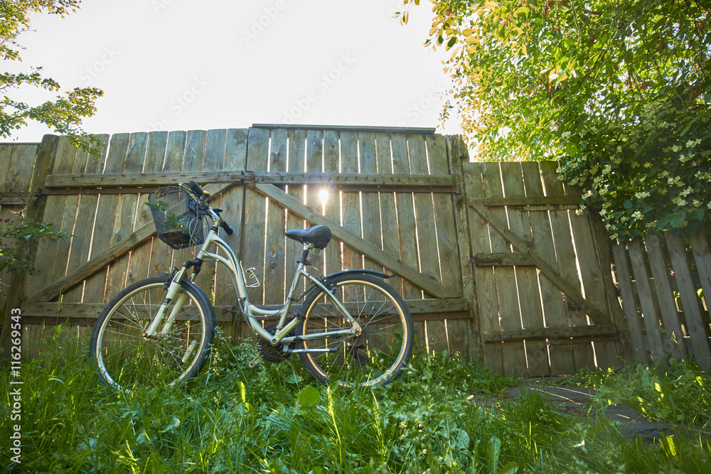 bicycle at the gate of the village bicycle at the gate of the village