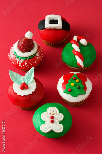 Christmas cupcakes on red background