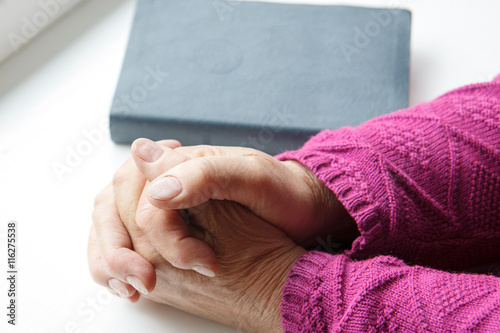 elderly women hands crossed in prayer  © aigarsr