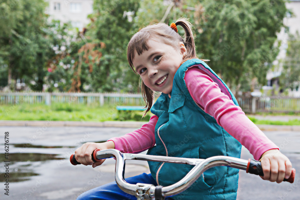 Smiling little girl on a bicycle. Smiling little girl on a bicycle.