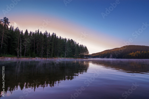 Sunrise over foggy lake