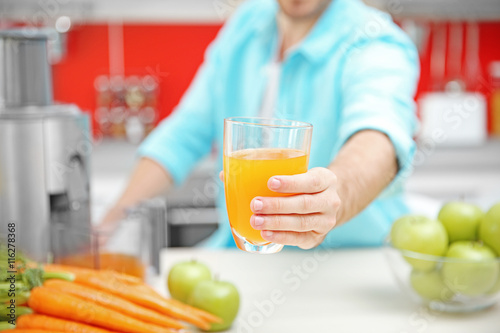 Man with juice in kitchen