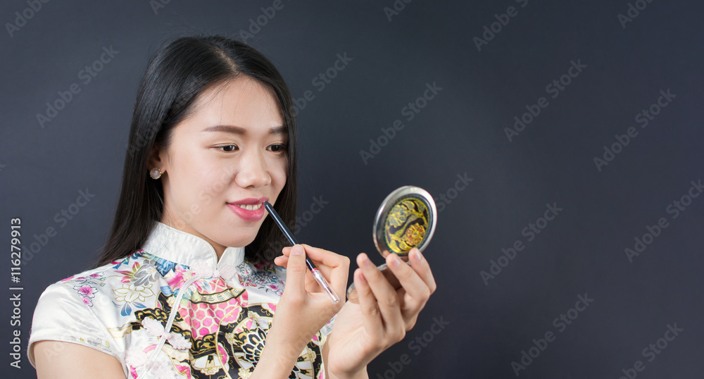Beautiful young asian woman applying makeup Beautiful young asian woman applying makeup