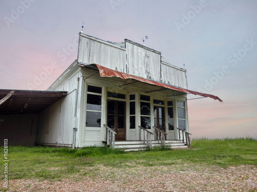 Vintage old abandoned western saloon storefront in disrepair