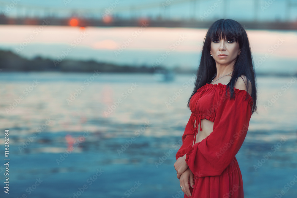Portrait of woman on a river bank at sunset. Portrait of woman on a river bank at sunset.