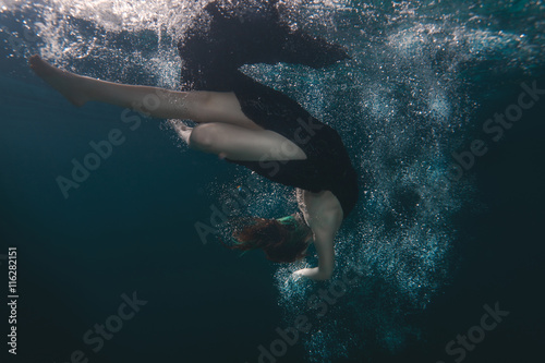 Woman dress dives underwater. © Petro