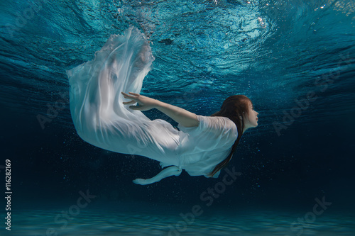 Fotografie, Tablou Woman in a white dress under water.