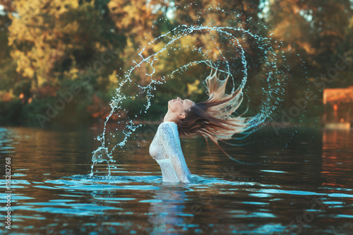 Billede på lærred Woman emerged with a splash of water.