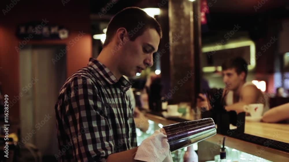Young bartender working at the bar Young bartender working at the bar