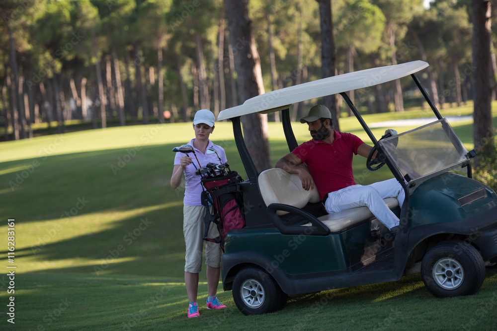 couple in buggy on golf course couple in buggy on golf course