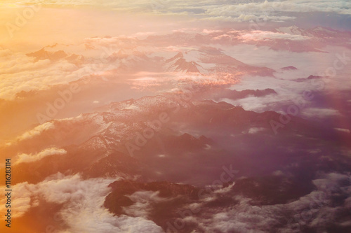 Sunset Over Mountains From Height Of Airplane. Bright Orange,