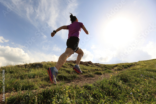 healthy young woman trail runner running on beautiful mountain peak © lzf